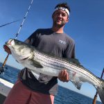 Guy with a striped bass he caught