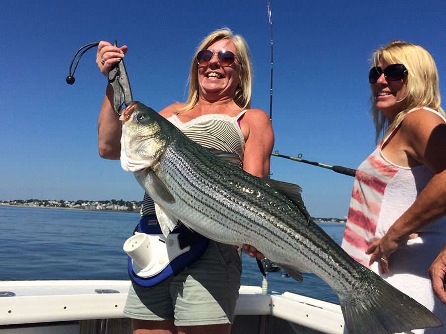 Two ladies with a nice striped bass